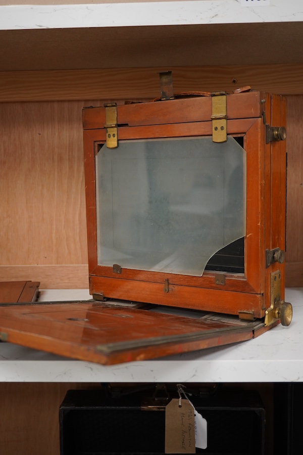 An early 20th century brass mounted mahogany full plate camera, together with a glass negative holder. Condition - fair to good.